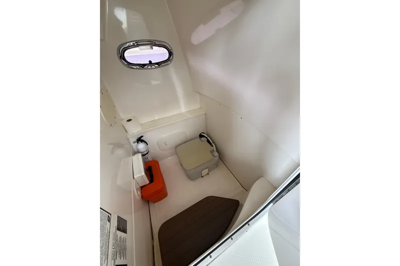 Slide: The Image of Interior of 2015 Boston Whaler 270 Dauntless boat with compact restroom amenities. - 27