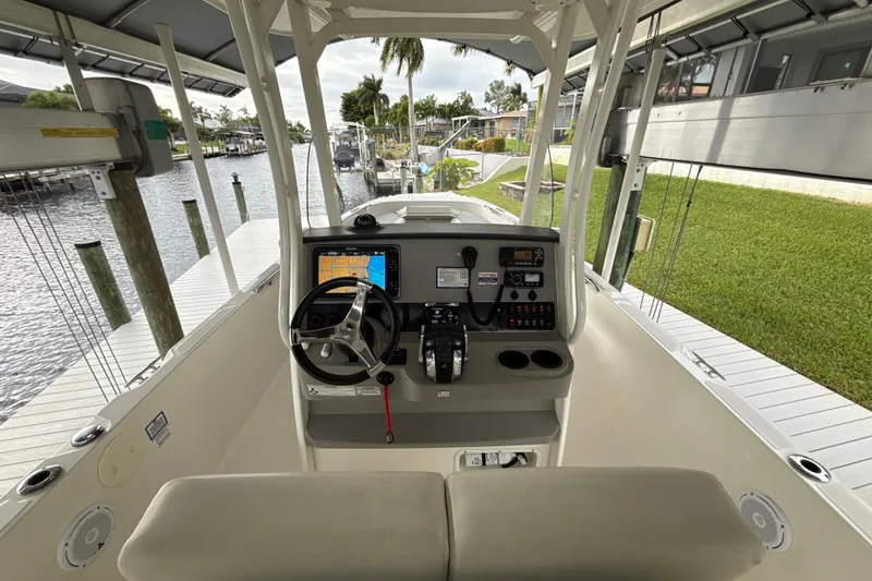 Slide: The Image of 2015 Boston Whaler 270 Dauntless boat cockpit with steering wheel and navigation system. - 3