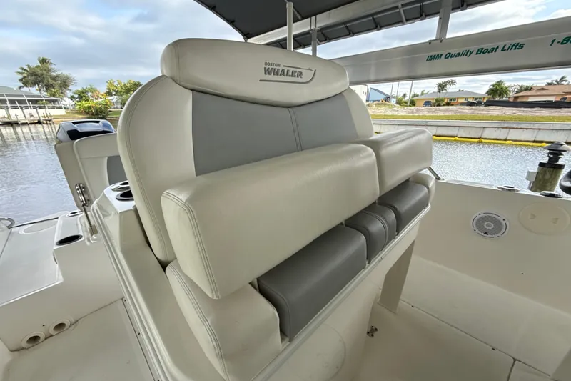 Slide: The Image of 2015 Boston Whaler 270 Dauntless boat seat, docked near waterfront homes. - 7