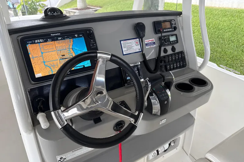Slide: The Image of 2015 Boston Whaler 270 Dauntless helm with navigation system and controls. - 8