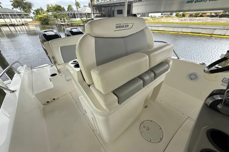 Slide: The Image of 2015 Boston Whaler 270 Dauntless boat interior with seating and dual engines. - 9