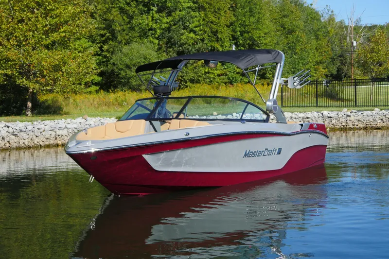 Slide: The Image of 2022 MasterCraft XT23 boat on calm water, featuring sleek design and vibrant colors. - 2