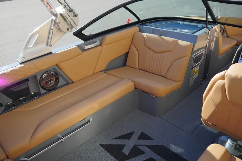 Slide: The Image of 2022 MasterCraft XT23 interior with tan leather seating and modern design features. - 9