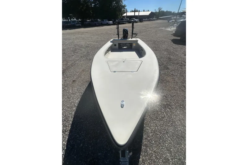 Slide: The Image of 2026 Delta Boatworks Delta D18 on gravel lot, sunlight reflecting off bow. - 10