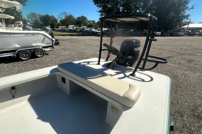 Slide: The Image of 2026 Delta Boatworks Delta D18 with Suzuki outboard motor in a boatyard. - 12