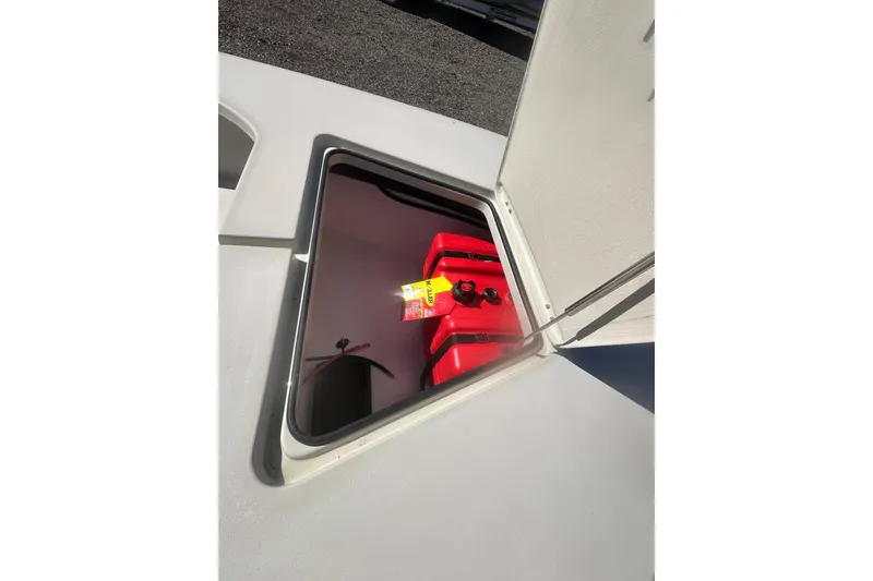 Slide: The Image of Open hatch on 2026 Delta D18 boat revealing red fuel tank inside. - 14