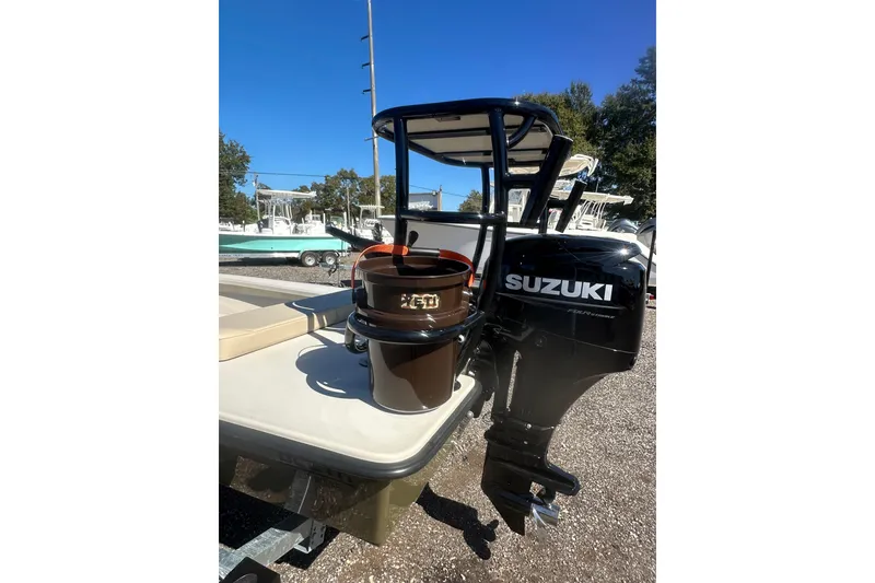 Slide: The Image of 2026 Delta Boatworks Delta D18 with Suzuki outboard motor, parked outdoors. - 17