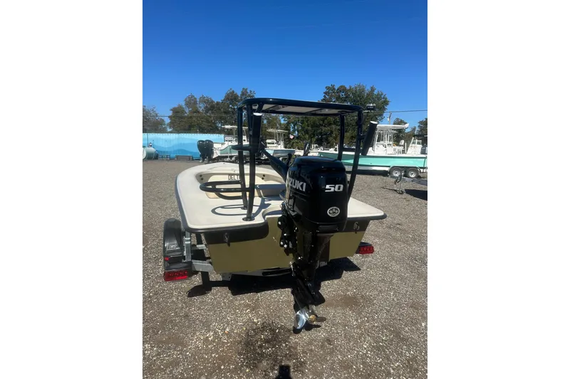 Slide: The Image of 2026 Delta Boatworks Delta D18 with Suzuki 50 outboard motor, parked outdoors. - 4