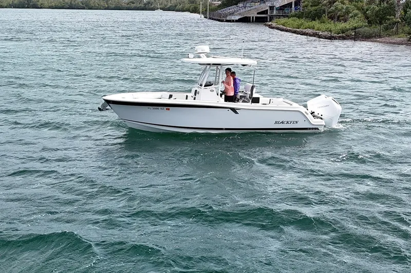 The Image of 2021 Blackfin 252 CC boat cruising on a scenic waterway. - 0