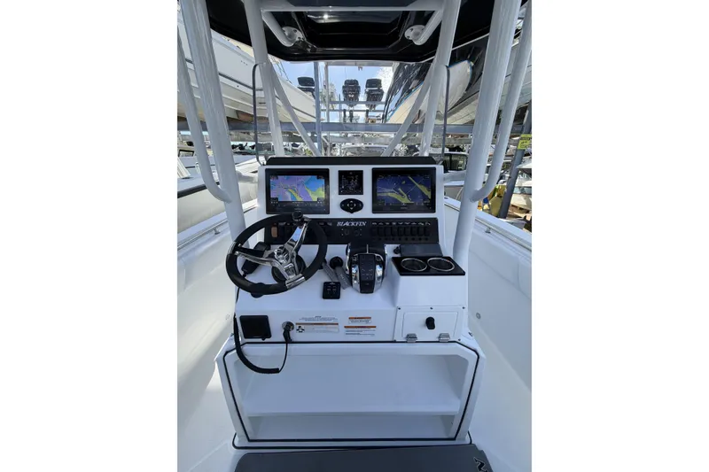 Slide: The Image of 2021 Blackfin 252 CC boat console with steering wheel and navigation screens. - 12