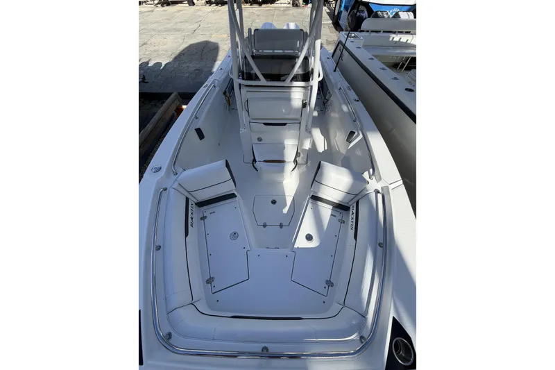 Slide: The Image of 2021 Blackfin 252 CC boat interior with dual seating and storage compartments. - 18