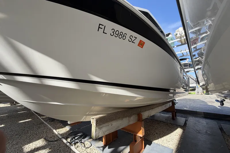 Slide: The Image of 2021 Blackfin 252 CC boat docked in marina, side view. - 3