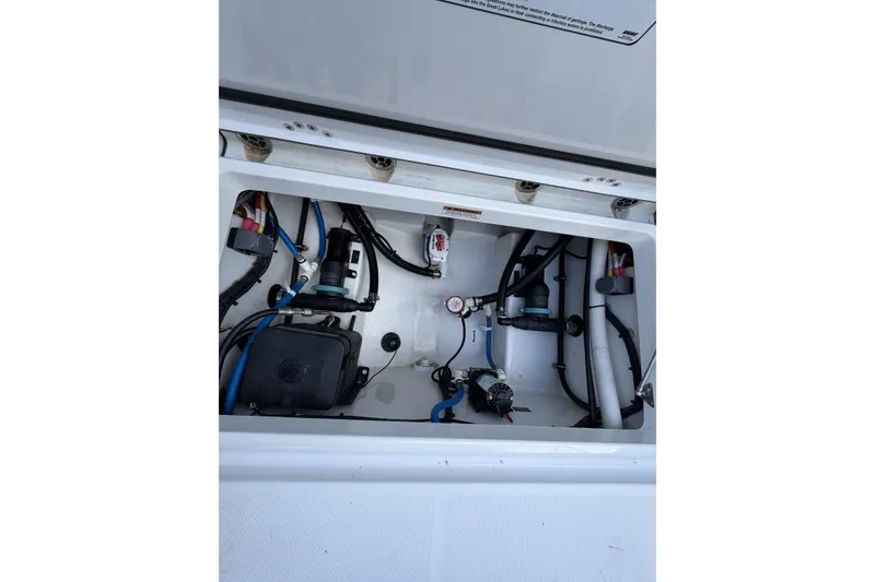 Slide: The Image of 2021 Blackfin 252 CC boat compartment with wiring and mechanical components. - 9