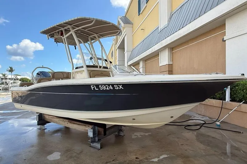 Slide: The Image of 2017 Scout 195 Sportfish boat on display, parked outside a building. - 1