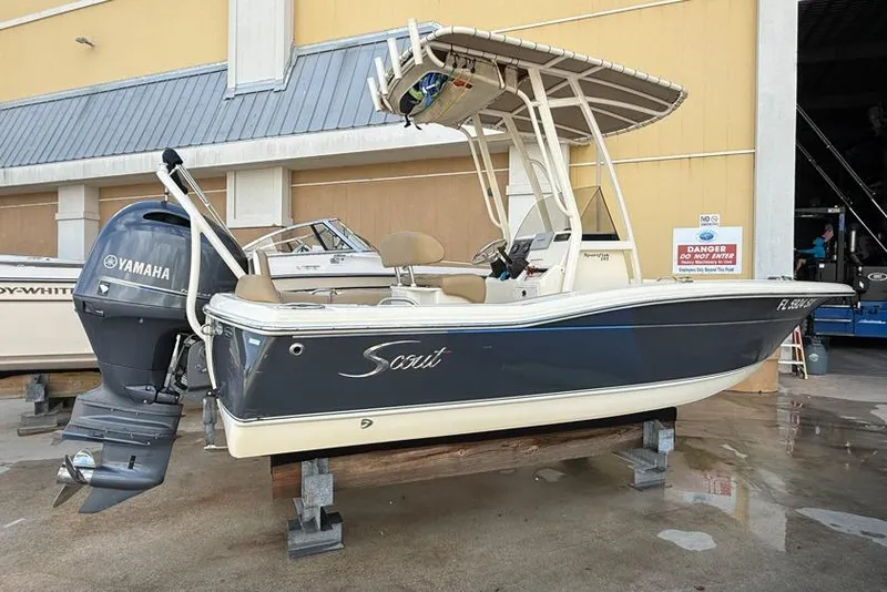 Slide: The Image of 2017 Scout 195 Sportfish boat with Yamaha outboard motor, docked indoors. - 3