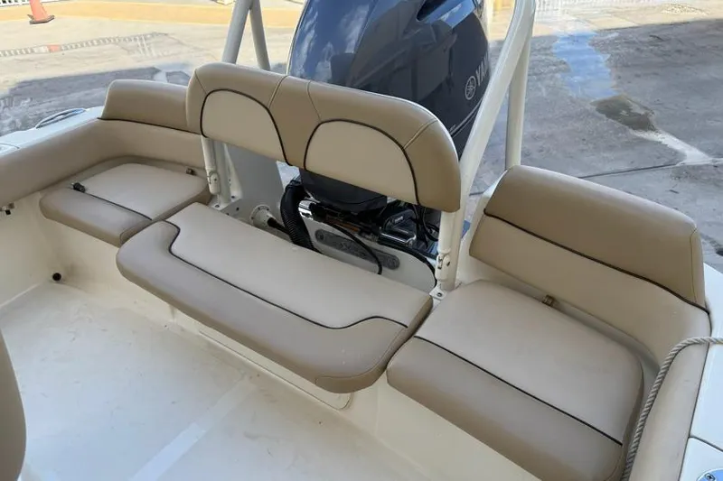 Slide: The Image of 2017 Scout 195 Sportfish boat seating with beige cushions and Yamaha outboard motor. - 4