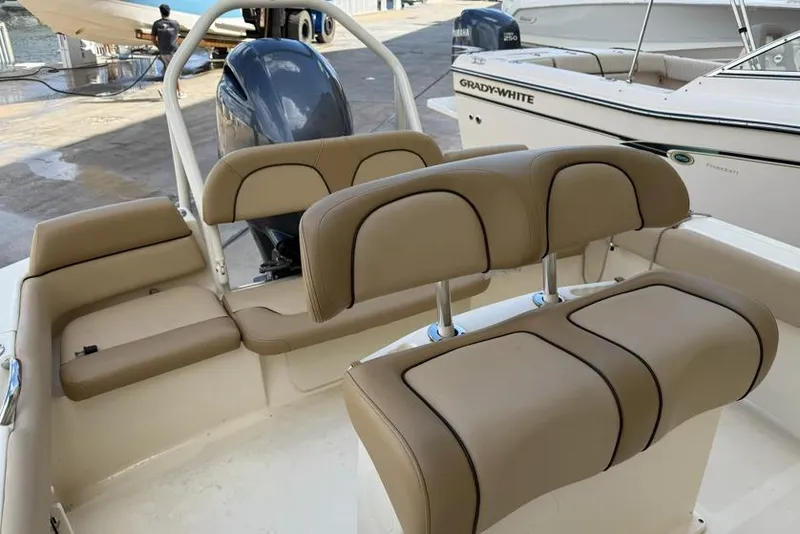 Slide: The Image of 2017 Scout 195 Sportfish boat interior with tan seating and Yamaha outboard motor. - 5