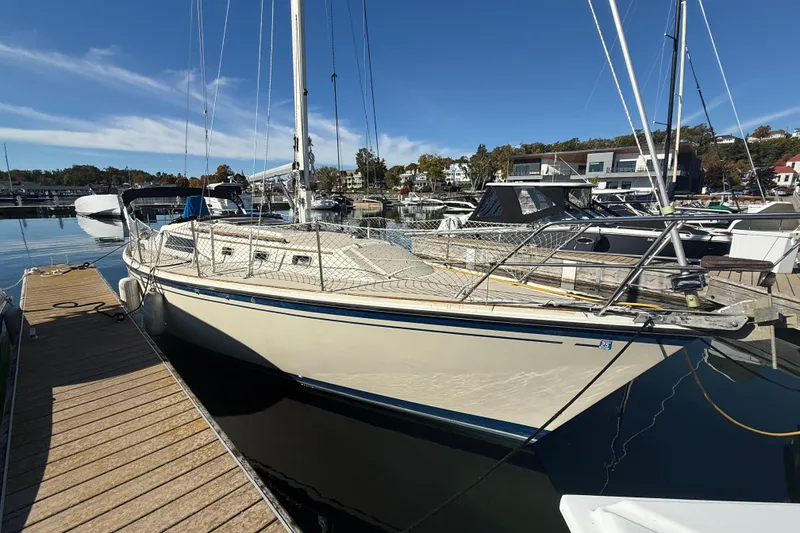 The Image of 1983 O'Day 34 sailboat docked at a marina under clear blue skies. - 0