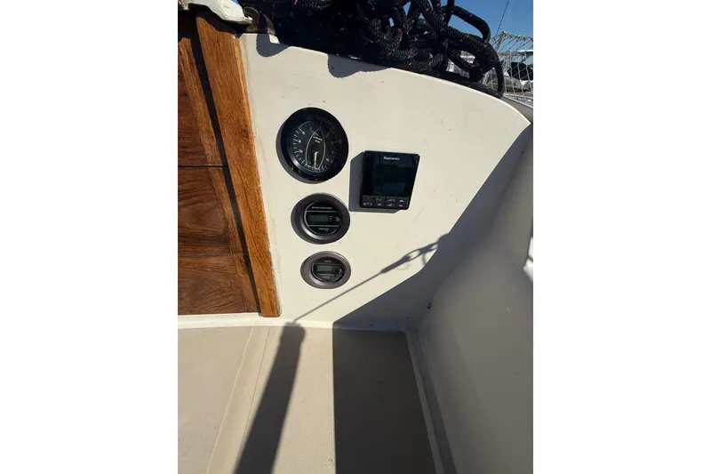 Slide: The Image of 1983 O'Day 34 sailboat cockpit with gauges and navigation equipment. - 12