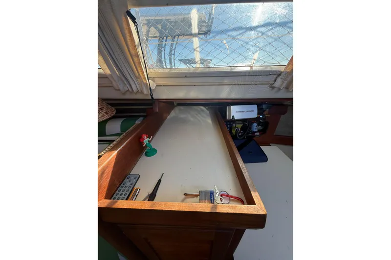 Slide: The Image of 1983 O'Day 34 sailboat interior with navigation desk and window view. - 17