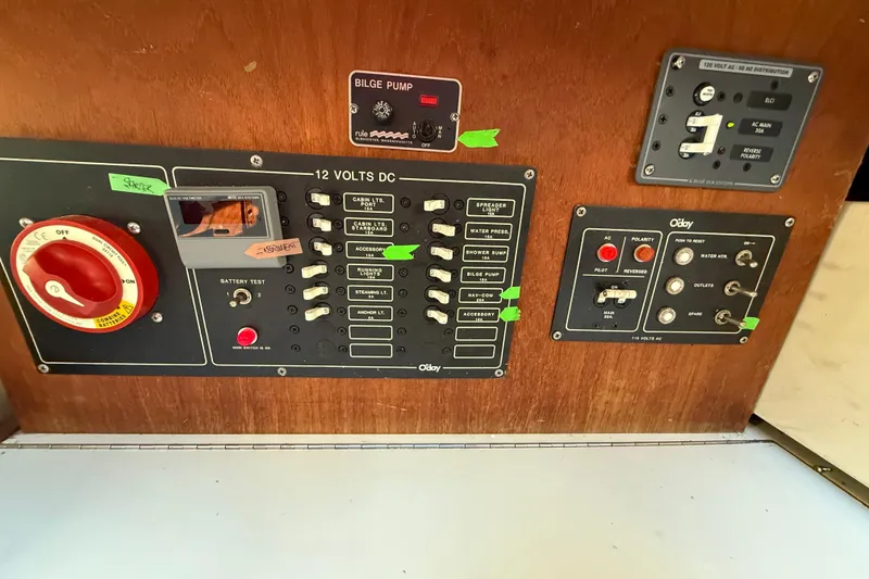 Slide: The Image of Electrical control panel of a 1983 O'Day 34 sailboat with various switches and indicators. - 21