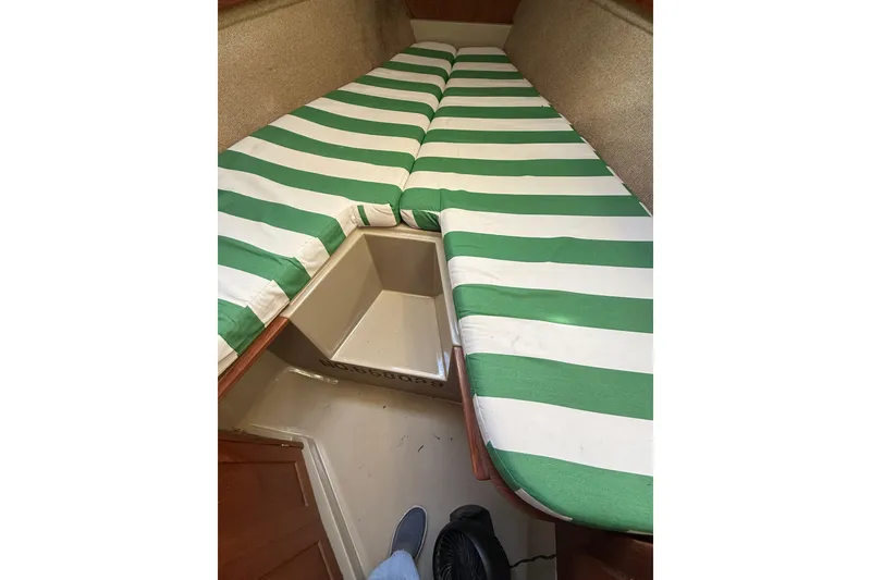 Slide: The Image of Interior of 1983 O'Day 34 sailboat with green-striped cushions in cabin. - 26
