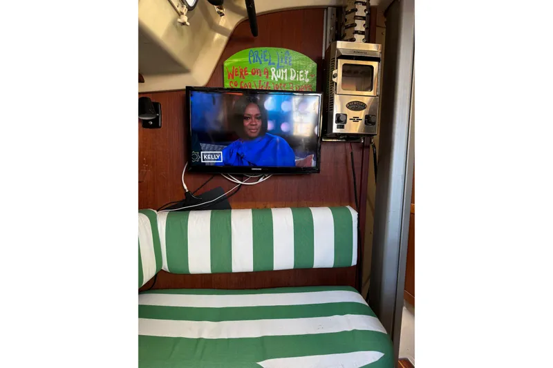 Slide: The Image of Interior of 1983 O'Day 34 sailboat with TV and striped seating. - 29