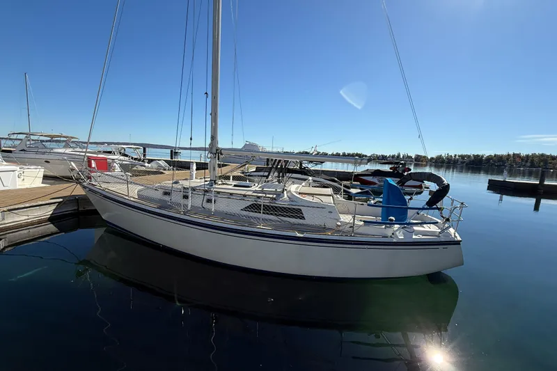 Slide: The Image of 1983 O'Day 34 sailboat docked at a marina on a sunny day. - 3
