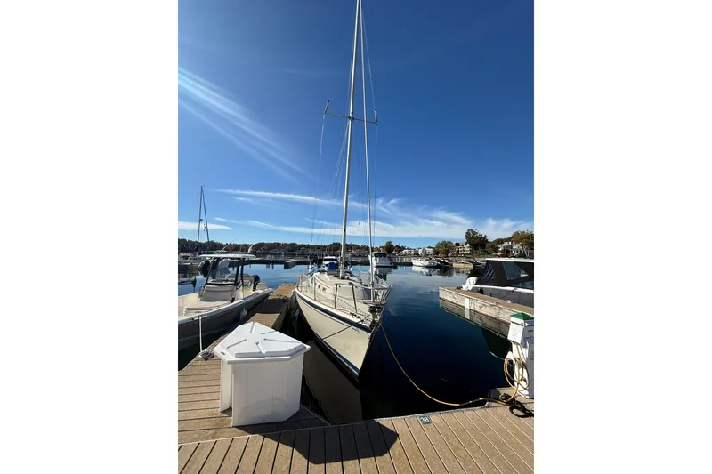 Slide: The Image of 1983 O'Day 34 sailboat docked at a marina under clear blue skies. - 5