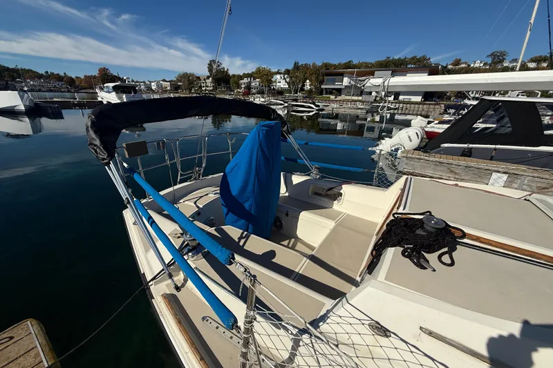 Slide: The Image of 1983 O'Day 34 sailboat docked at a marina under clear blue skies. - 7
