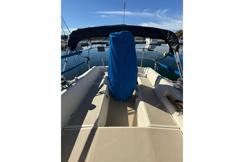 Slide: The Image of 1983 O'Day 34 sailboat cockpit with blue cover, docked in marina. - 8