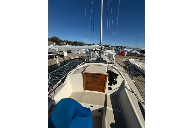 Slide: The Image of 1983 O'Day 34 sailboat docked, showcasing deck and rigging under clear blue sky. - 9