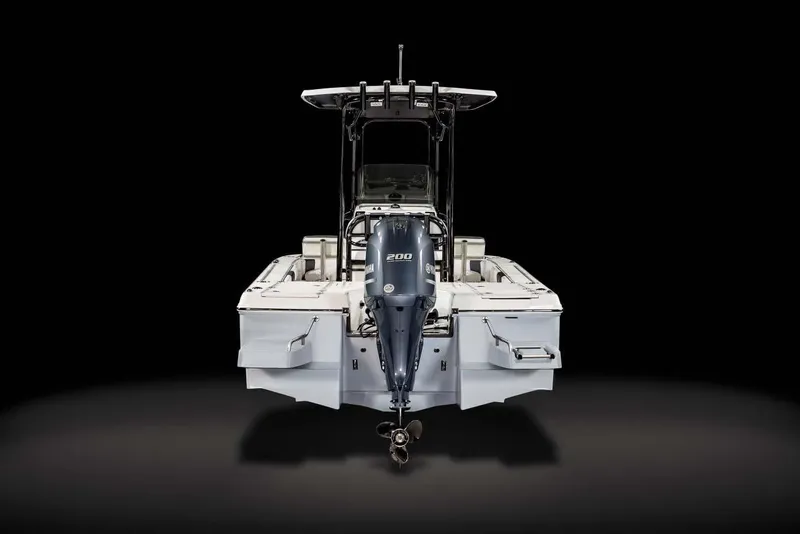 Slide: The Image of 2026 Robalo 226 Cayman boat interior with seating and engine at a boat show. - 6