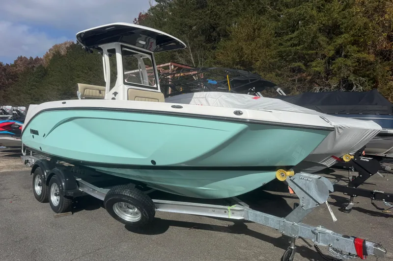 The Image of 2026 Yamaha Boats 222 FSH Sport E on trailer, light blue hull, outdoor setting. - 0