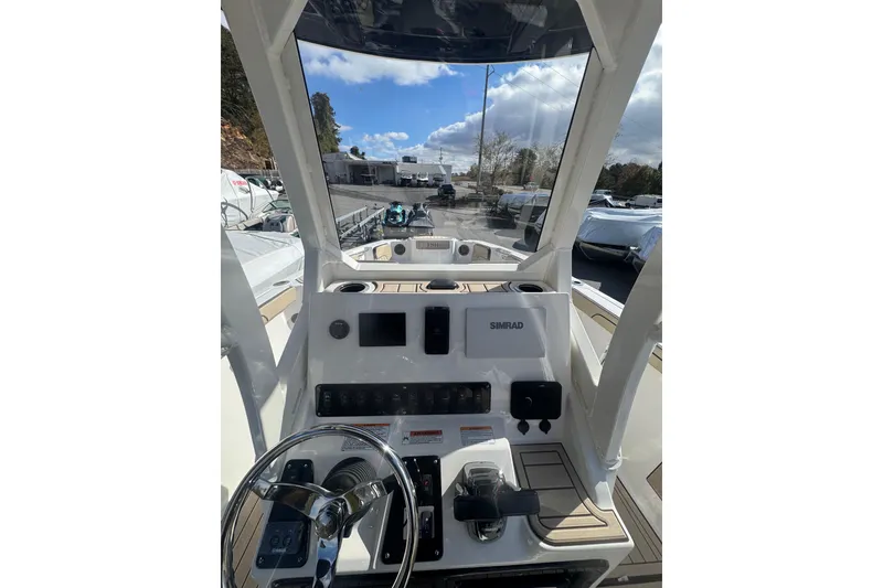 Slide: The Image of 2026 Yamaha Boats 222 FSH Sport E dashboard with steering wheel and controls. - 21