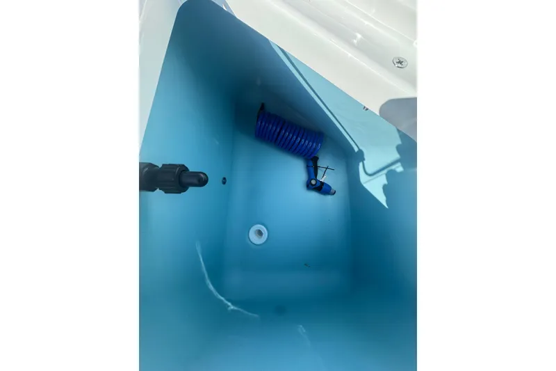 Slide: The Image of Interior view of Yamaha Boats 2026 model 222 FSH Sport E, featuring a blue compartment. - 22