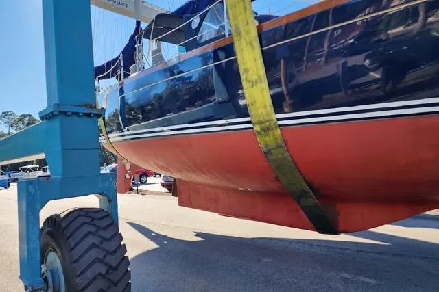 Slide: The Image of 1984 Bristol 45.5 Center Cockpit sailboat in dry dock, supported by a lift. - 11
