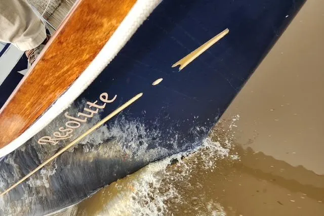 Slide: The Image of Bristol 45.5 Center Cockpit sailboat named "Resolute" cutting through water, 1984 model. - 13