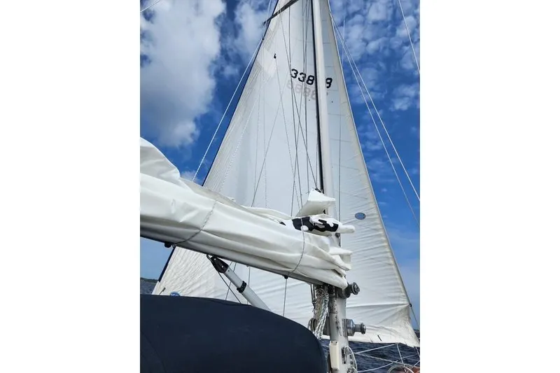 Slide: The Image of Sailing yacht Bristol 45.5 Center Cockpit, 1984, with white sails against a blue sky. - 14