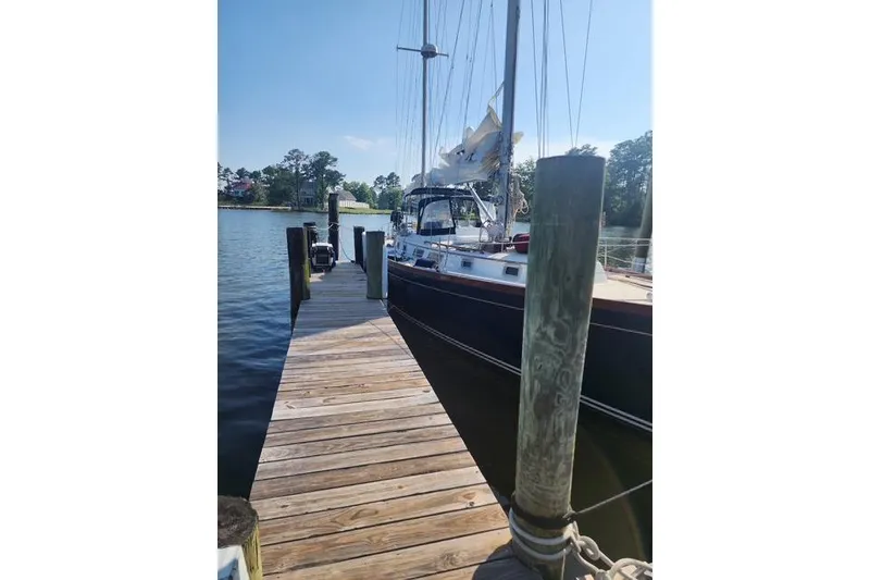 Slide: The Image of 1984 Bristol 45.5 Center Cockpit sailboat docked at a wooden pier. - 2