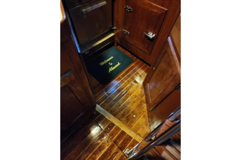 Slide: The Image of Interior of 1984 Bristol 45.5 Center Cockpit with polished wood flooring and welcome mat. - 23