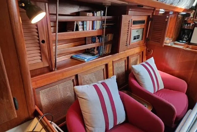 Slide: The Image of Cozy interior of 1984 Bristol 45.5 Center Cockpit with red chairs and wooden shelves. - 24