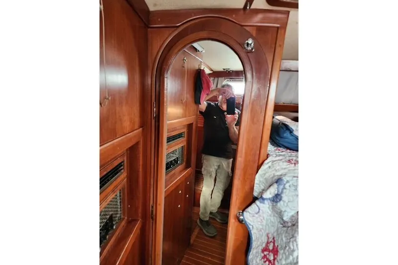Slide: The Image of Interior of 1984 Bristol 45.5 Center Cockpit with wooden cabinetry and mirror reflection. - 26