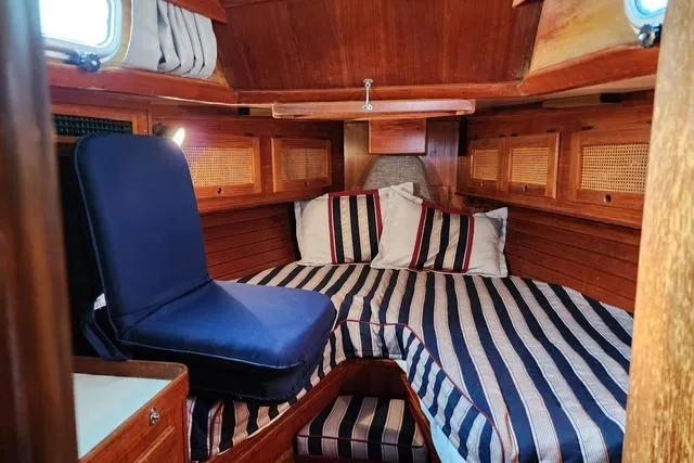 Slide: The Image of Cozy cabin interior of 1984 Bristol 45.5 Center Cockpit sailboat with striped bedding. - 29