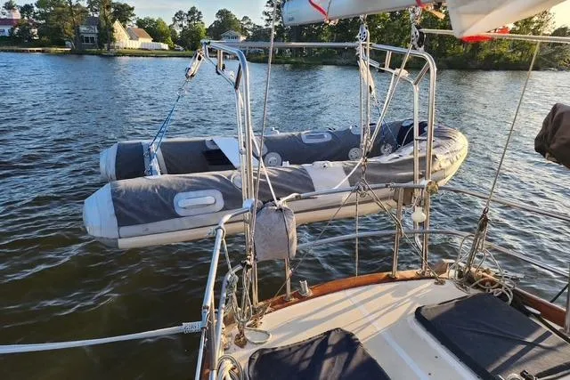 Slide: The Image of Sailboat with dinghy on davits, Bristol 45.5 Center Cockpit, 1984, on calm water. - 6