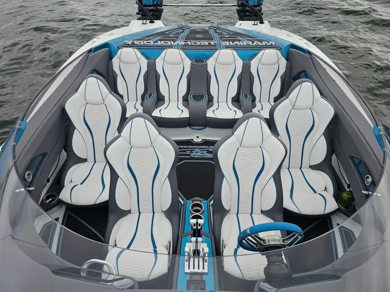Slide: The Image of Luxury MTI 440X 2026 boat interior with sleek white and blue seating on water. - 11