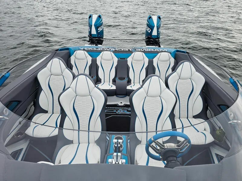 Slide: The Image of Luxury MTI 440X 2026 speedboat interior with white and blue seating, dual engines, on water. - 12