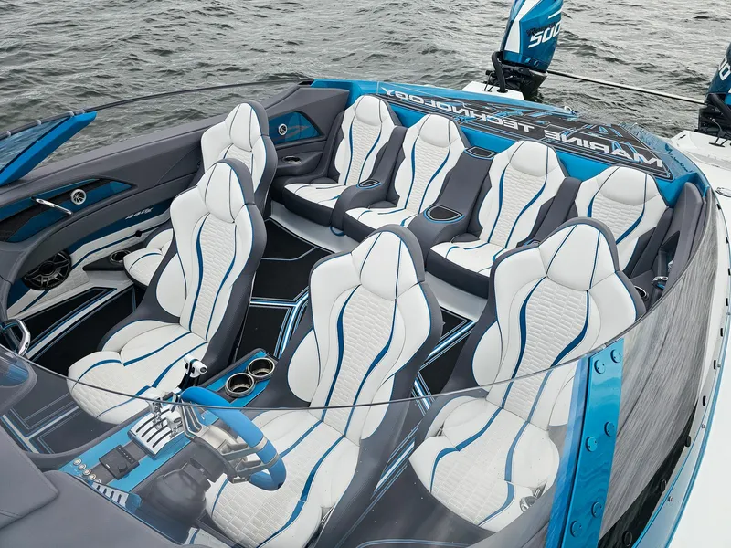 Slide: The Image of Luxurious MTI 440X 2026 speedboat interior with sleek white and blue seating design. - 14