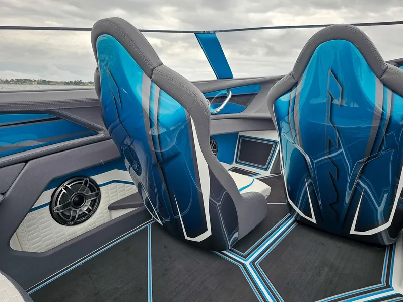 Slide: The Image of Interior of 2026 MTI 440X boat with sleek blue seats and modern design. - 19