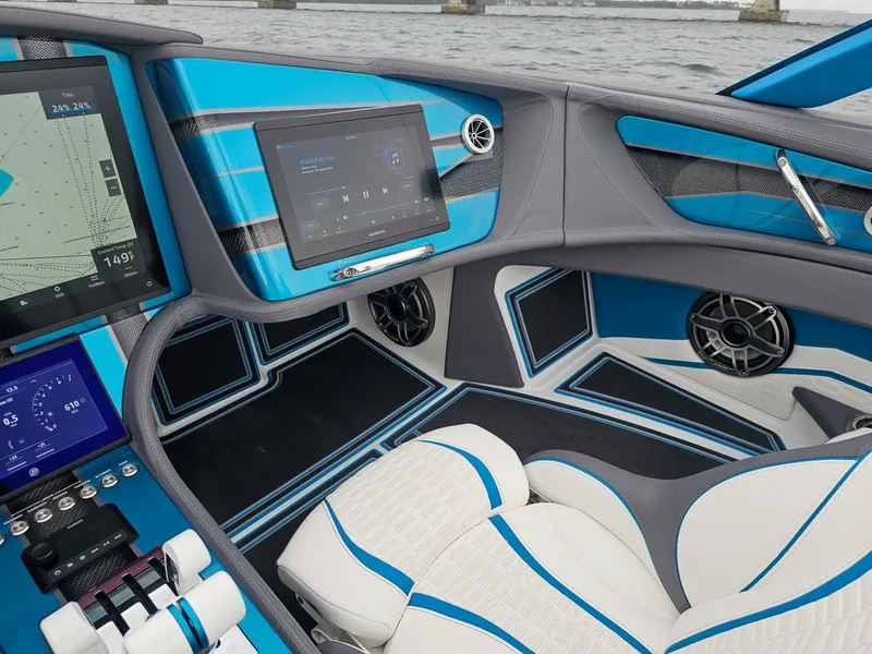 Slide: The Image of Interior of 2026 MTI 440X boat with modern blue and white design, featuring advanced navigation displays. - 24